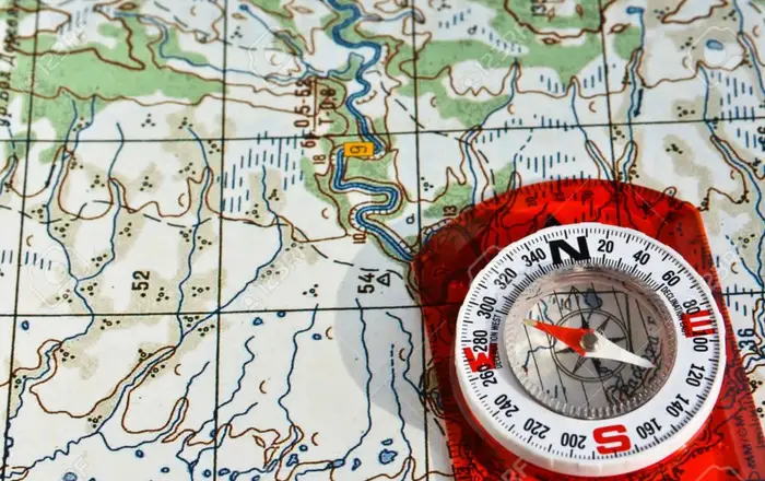 physical compass on a topographic map
