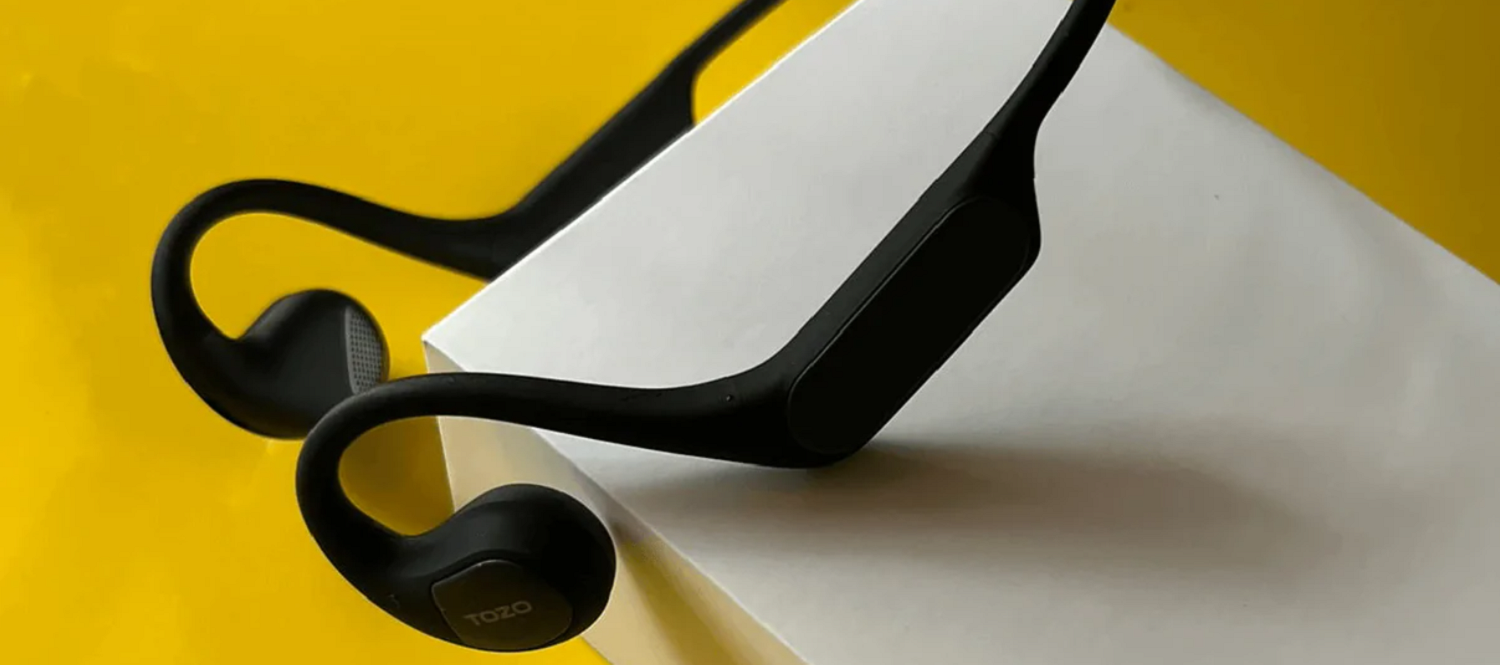 tozo earphones with yellow background